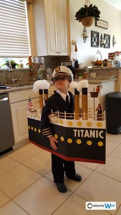 a little boy in a costume that is made to look like a boat