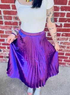 Playfully strut your stuff in this Pleated A-Line Satin Feel Midi Skirt, guaranteed to add a touch of whimsical charm to any outfit. True to size fit! Small: 2/4 Medium: 4/6 Large: 8/10 Disclaimers; Our product colors may vary due to lighting and screen resolutions. Purple Pleated Bottoms For Spring, Purple Stretch Skirt For Night Out, Stretch Purple Skirt For Night Out, Trendy Pleated Stretch Skirt, Trendy Stretch Pleated Skirt, Trendy Stretch Midi Skirt, Spring Party Skirt In Purple, Purple Skirt For Fall Party, Purple Party Skirt For Spring