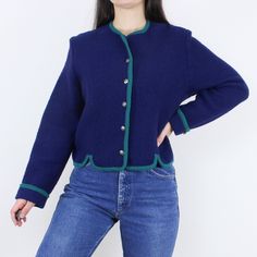 Item Description  This is a gorgeous vintage Tally Ho boiled wool cardigan sweater in a dark navy blue and forest green color pairing. I love the shape of these, with the cropped fit, structured shoulders, and crew neckline. I really like the notches on the front bottom hem as well. This has decorative buttons down the front and one on each cuff, as well as an extra button sewn onto the inside. This piece is in excellent vintage condition!  Item Specifics  Brand - Tally Ho Material - 100% Wool C Blue Wool Cardigan With Buttons, Blue Wool Sweater With Buttons, Blue Winter Sweater With Button Cuffs, Austrian Style, Tally Ho, Sweater Navy Blue, Forest Green Color, Boiled Wool, Color Pairing