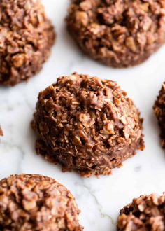 chocolate no bake cookies are arranged on a white surface with one cookie in the middle