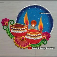 this is an image of diwali rangolim with candles in the middle