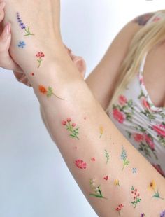 a woman with flowers painted on her arm