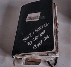 a black book with writing on it hanging from the wall