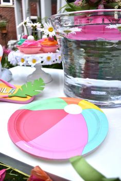 a table topped with plates and cups filled with flowers