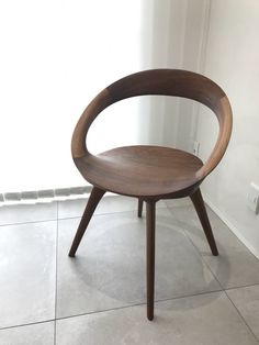 a wooden chair sitting on top of a tile floor