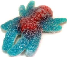 a pair of blue and red gloves sitting on top of a white table next to each other