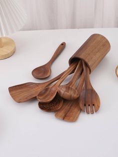 wooden utensils and spoons on a white table