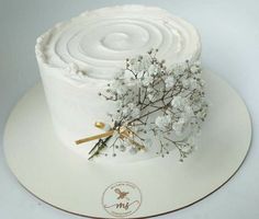 a cake with white frosting and flowers on top