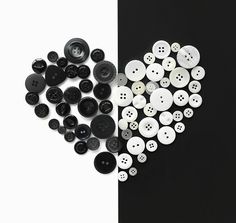 several black and white buttons laying next to each other