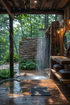 an outdoor shower in the middle of a wooden decked area with lights on above it