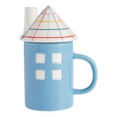 a blue coffee mug with a small house on it's side and a white top