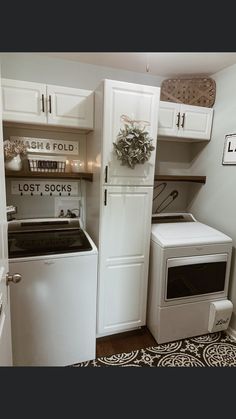 a white washer and dryer sitting next to each other in a laundry room