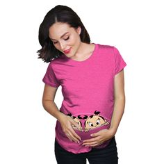 a woman in pink shirt holding her stomach