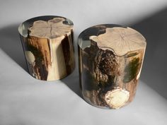 two wooden stools with designs on them