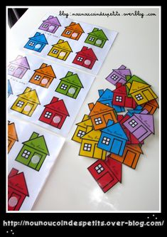 colorful houses cut out from paper on top of a white table with text overlay