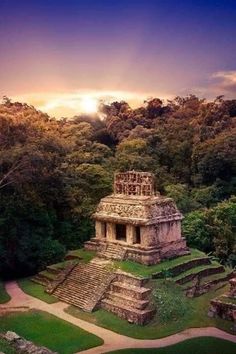 the sun is setting over an ancient temple in the jungles, with trees surrounding it