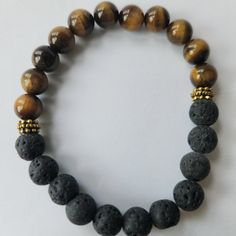 Nwt Lava Rock, Tiger Eye Beaded Bracelet. Lava Rock Is Made Of The Earth's Core And Is A Stone With A Special Connection To Mother Earth. This Is The Best Stone For Grounding, Stress Relief, Emotional Support, 8mm. For New Poshers, Enter Code Stephaniekj73 To Get $10 Off Your First Purchase! Casual Brown Bracelet With Black Beads, Casual Brown Bracelets With Black Beads, Casual Beaded Lava Stone Bracelets, Casual Black Lava Stone Beaded Bracelets, Casual Black Beaded Lava Stone Bracelets, Adjustable Brown Beaded Bracelets With Black Beads, Casual Brown Beaded Bracelets With Gemstone Beads, Casual Brown Beaded Bracelets With Gemstones, Casual Brown Round Beads Bracelets