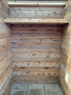 the inside of a wooden sauna with tile flooring