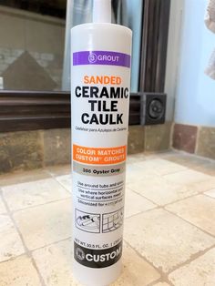 a bottle of sanded ceramic tile caulk