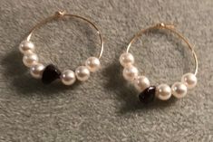 Hoop earrings made with black stones and white beaded pearls. Handmade Elegant Round Hoop Earrings, Elegant Handmade Hoop Earrings With Round Beads, Beaded Pearl Hoop Earrings As Gift, Beaded Pearl Hoop Earrings For Gift, Pearl Beaded Hoop Earrings As Gift, Beaded Pearl Hoop Earrings, Elegant Pearl Beaded Hoop Earrings, White Bead Earrings, Black Stones