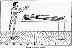 a man standing in front of a drawing of a person laying on the floor and pointing at him