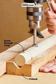 a person using a drill to make a piece of wood with a router on it