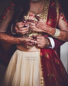 the bride and groom are getting ready to take their wedding pictures with henna tattoos