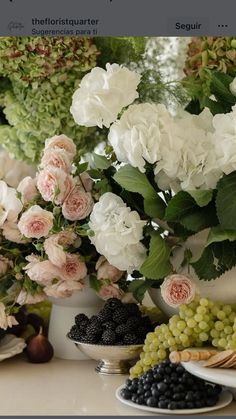 a table topped with plates filled with fruit and flowers