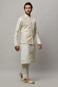 Raw Silk Kurta with intertwined sequence and thread work on the vest plus matching pants. Crafted with a collar neckline, full sleeves, and front button closure. Occasion: Can be worn to events like Sangeet, Mehendi, & Wedding WASH CARE INSTRUCTIONS - Please Dry clean only when it is applicable. Slight color variation is possible due to digital photography. Fitted Kurta With Set-in Sleeves For Festive Occasions, Fitted Kurta With Set-in Sleeves For Wedding, Fitted Wedding Kurta With Set-in Sleeves, Festive Fitted Kurta With Set-in Sleeves, Thread Work, Raw Silk, Full Sleeve, Digital Photography, Latest Fashion