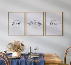 three posters with the words food, family and love hanging on a wall above a dining room table