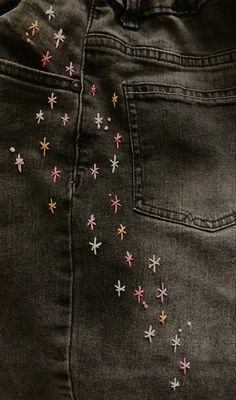 a pair of jeans with small stars on them