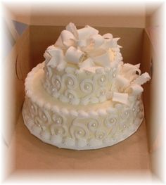 a white wedding cake in a box