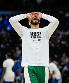 a man with his head in his hands during a basketball game