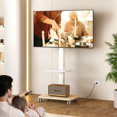 a man and child watching television in the living room