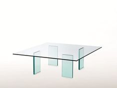 a glass table sitting on top of a white floor