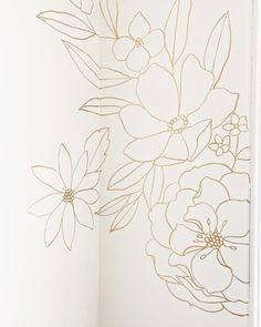 an open book with flowers drawn on the pages and gold foiled paper in it