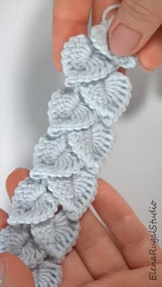 someone is crocheting something with their fingers