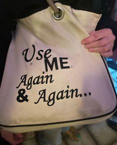 a person holding a bag with the words use me again and again written on it