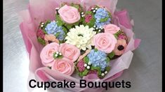 a cupcake bouquet with pink and blue flowers