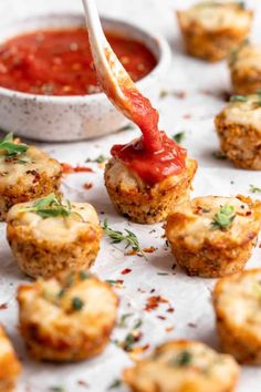 small appetizers with sauce and parmesan bread on a white tablecloth