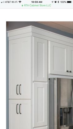 a white refrigerator freezer sitting inside of a kitchen next to a wall mounted microwave