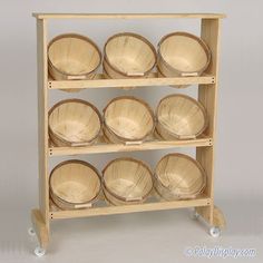 a wooden shelf filled with lots of empty plates and bowls on it's wheels