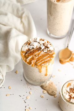 two glasses filled with dessert sitting next to each other