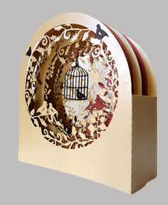 a birdcage with two birds in it is sitting on top of a card