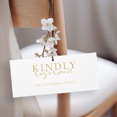 a sign that says kindly reserved for the bride's family on a wooden chair