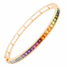 Discover the enchantment of the Multicolor Rainbow Channel Set Bracelet, a true embodiment of vibrant sophistication that celebrates nature's myriad of colors. This design pays homage to the beauty of diversity, presenting carefully chosen gemstones cradled within a seamless channel setting, resulting in a mesmerizing array of brilliant hues. Elegant Rainbow Colored Bangle Jewelry, Luxury Multicolor Gemstone Bracelets, Elegant Rainbow Multi-stone Bracelets, Rainbow Multi-stone Bracelet Jewelry, Rainbow Multi-stone Bracelet, Set Bracelet, Rainbow Gemstones, The Enchantments, Channel Setting