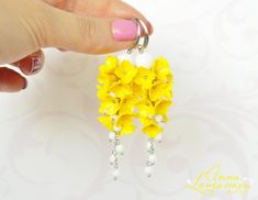 "Yellow earrings Yellow floral earrings gift White yellow long earrings Yellow polymer earrings Bright flower earrings Yellow wedding jewelry Flowers Long earrings with Yellow flowers, and supplemented with White glass beads. These earrings are perfect for a bride if you are having a yellow wedding. The earrings are great for the bridesmaid. Bright floral earings will be a perfect gift for her Accentuate your individuality with the help of these floral earrings! Yellow Flowers Lilacs, made of polymer clay. For these flowers I used high quality polymer clay Fimo. Each flower is made by hand in a special technique. The last photo shows the bracelet. A similar bracelet can be made to match your earrings. Length with hooks is about 8 cm/3.15\" ✿ THESE EARRINGS ARE READY TO SHIP! ✿ Real colors Elegant Yellow Dangle Flower Earrings, Elegant Yellow Flower Earrings For Wedding, Yellow Flower Drop Earrings For Wedding, Handmade Yellow Flower Earrings For Wedding, Handmade Yellow Flower Earrings For Gift, Yellow Flower-shaped Earrings With 3d Flowers, Yellow Flower Earrings With 3d Flowers, Yellow Flower-shaped Jewelry With 3d Flowers, Yellow Earrings With 3d Flowers As A Gift