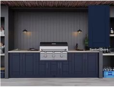 an outdoor kitchen with blue cabinets and counter tops is shown in this image, there are lights on above the grill