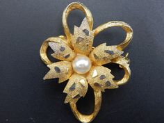 A lovely 1950s vintage brooch by Sphinx but unmarked apart from the pattern number to the reverse.  A gold-tone with a textured and raised surface with a slight silver-tone to the raised accents. Set to the centre with a faux pearl.  Horizontal pin and roll over clasp to the reverse.  A fab design and in good condition for just on 70 years old.                            Postage & Shipping                    buy as much as you like for only one shipping charge, we don't charge extra for addition Mid-century Gold Brooches For Vintage Events, Retro Gold Brooch For Evening, Retro Gold Brooches For Evening, Gold Retro Brooches For Evening, Gold Retro Wedding Brooches, Gold Leaf Necklace, Leaf Necklace, Vintage Brooch, 1950s Vintage