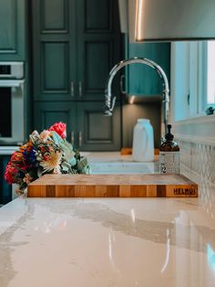 a kitchen counter top with flowers on it